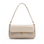 Elva Shoulder Bag with a glossy finish, decorative gold-tone clasp, front flap closure, and shoulder strap.