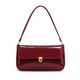 Elva Shoulder Bag with a glossy finish, decorative gold-tone clasp, front flap closure, and shoulder strap.