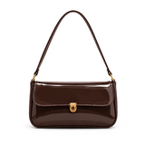 Elva Shoulder Bag with a glossy finish, decorative gold-tone clasp, front flap closure, and shoulder strap.
