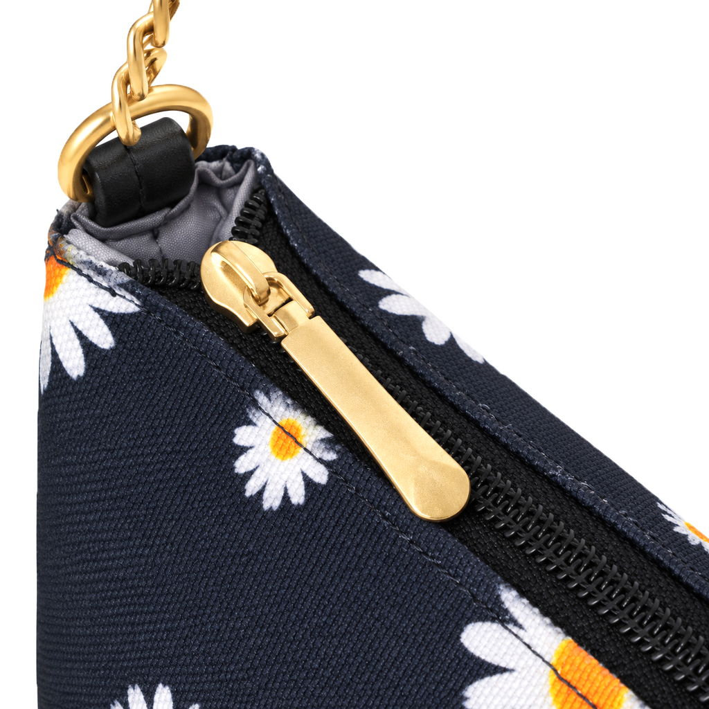 Dark daisy print shoulder bag with white and yellow flowers, a black strap, gold-tone chain links and a top zipper.
