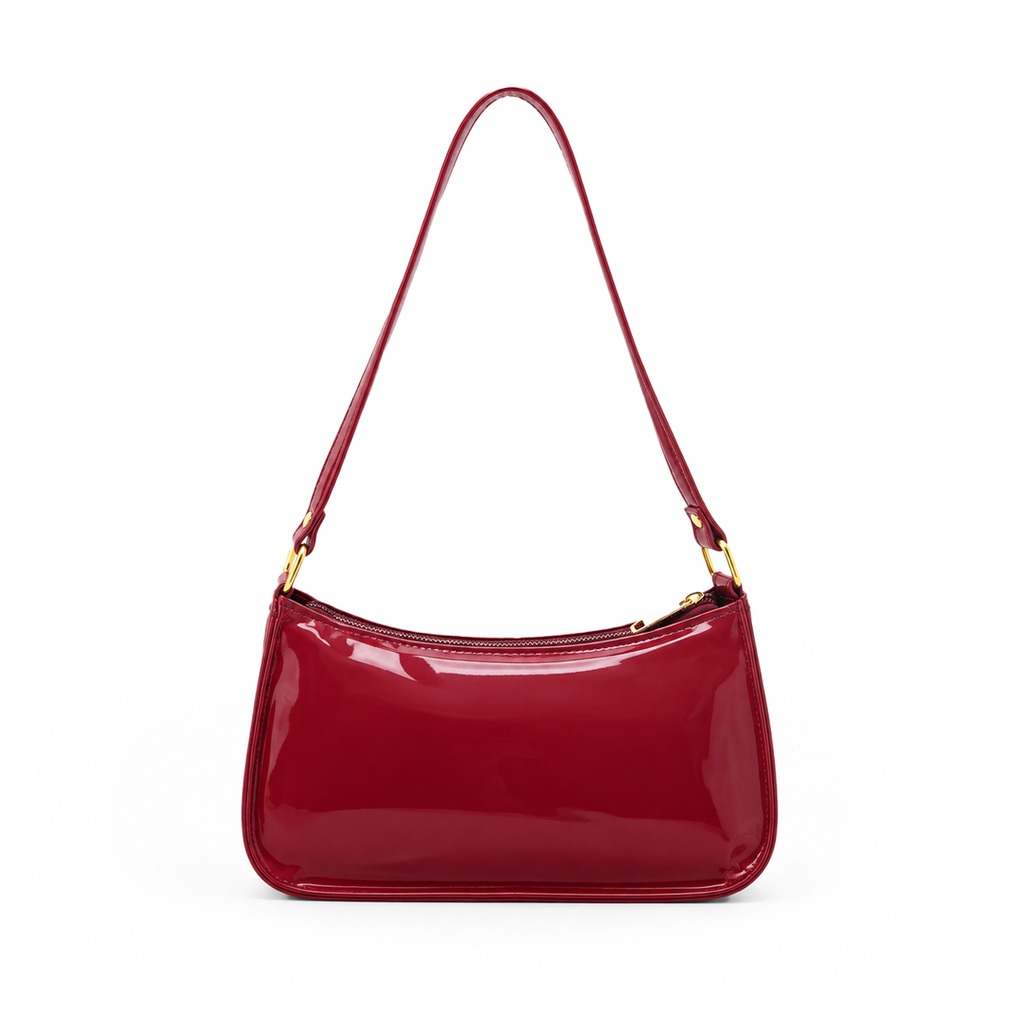 Glossy burgundy red women's shoulder bag with a long strap, zip closure and gold-tone hardware on a white background.