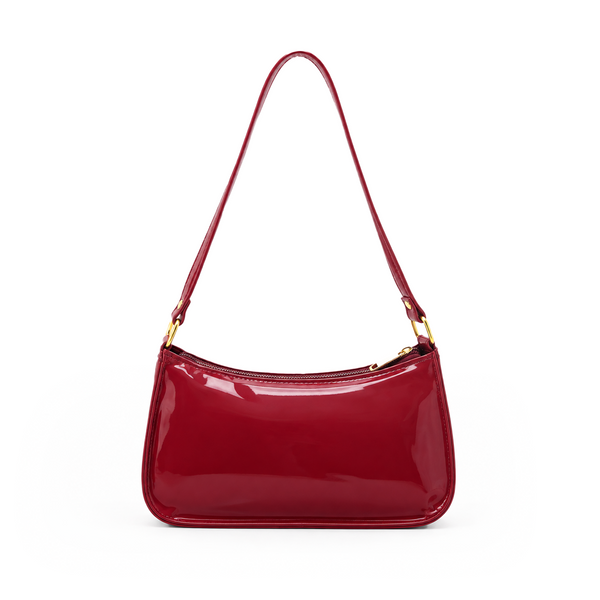 Glossy burgundy red women's shoulder bag with a long strap, zip closure and gold-tone hardware on a white background.